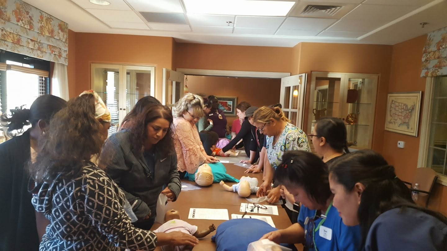 Group of students practicing CPR skills on training mannequins