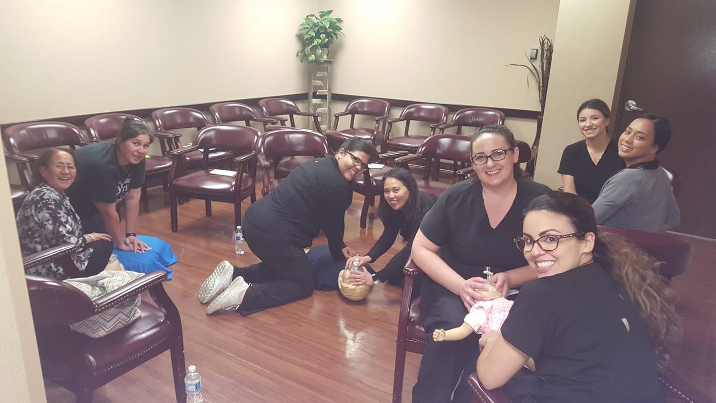 CPR students practicing infant resuscitation skills in a group class